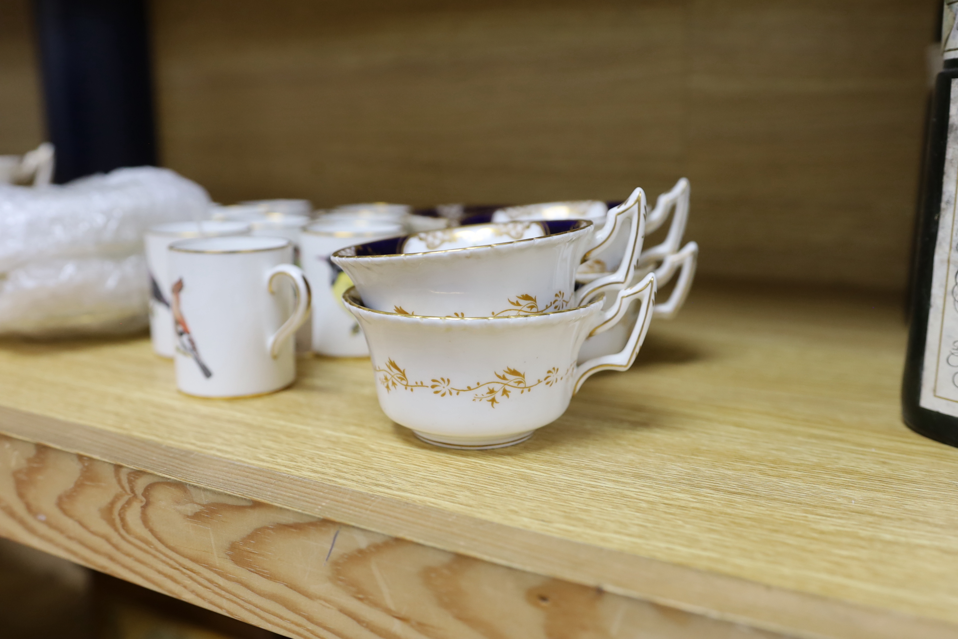 A Worcester bird decorated coffee set for ten and a Coalport tea set